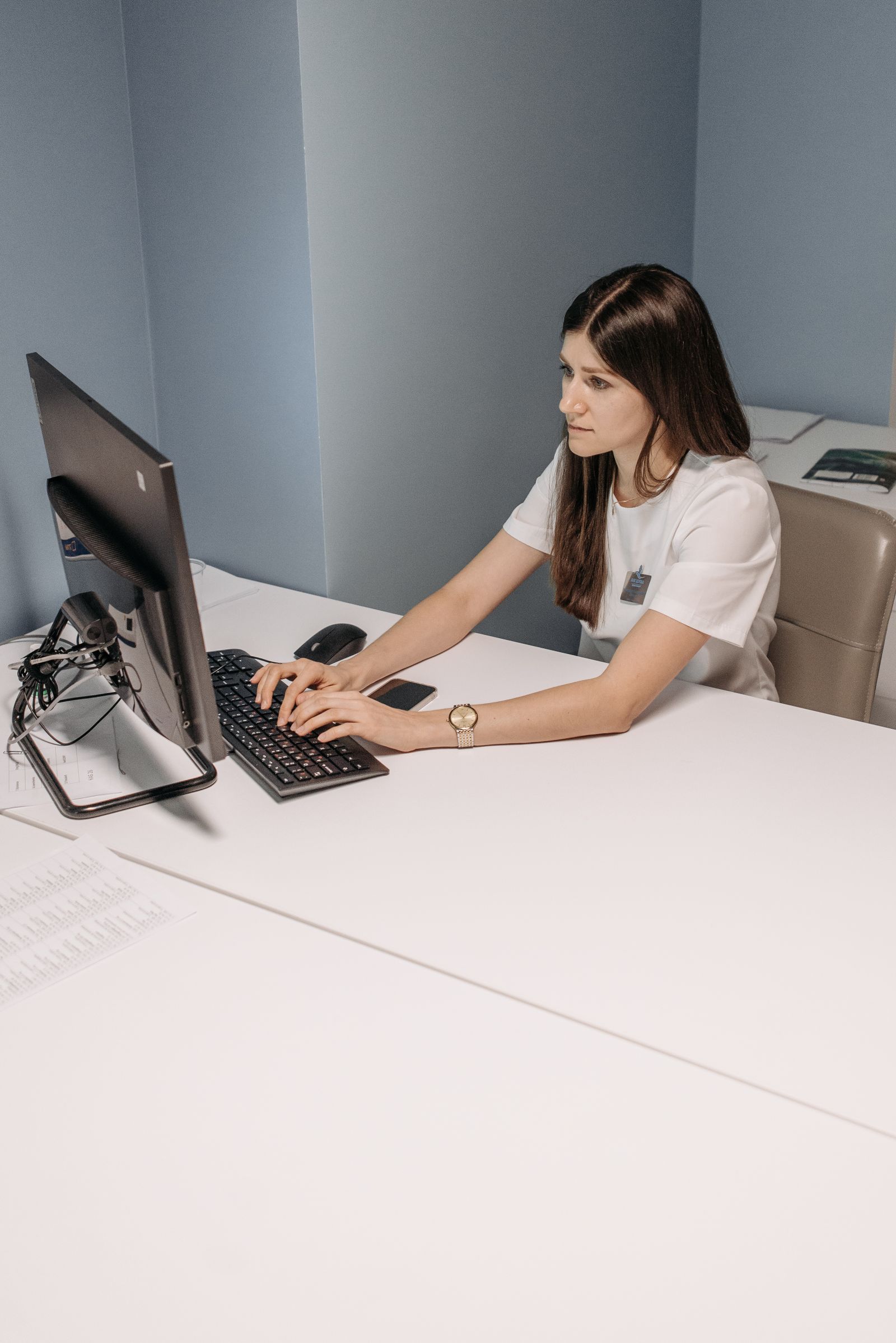 A healthcare administrator managing provider enrollment and payer status records